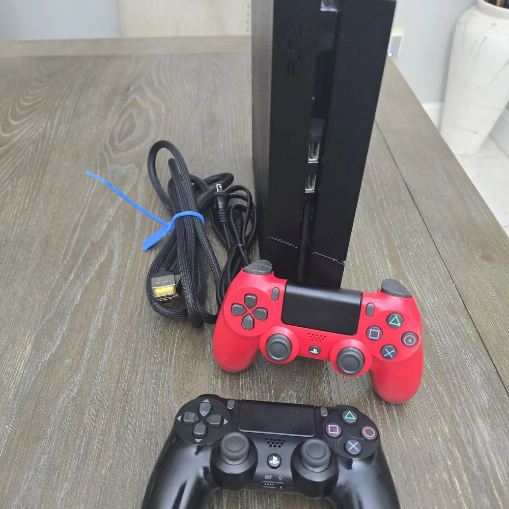 Sony PlayStation 4 Console with Black and Red Controllers